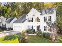 Two-story house with white siding, black shutters, and a two-car garage at 112 Sugar Thyme Ln, Mooresville, NC 28115