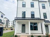 Charming townhouse featuring a modern farmhouse design with white siding and black accents at 12110 Storm Ln # 49, Charlotte, NC 28277