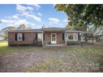 Charming brick home featuring a cozy front porch and well-maintained yard at 2243 Drive Inn Rd, Lincolnton, NC 28092