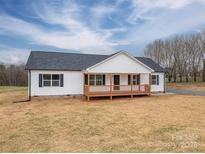 Exterior view of a single-story home with a welcoming front porch and ample yard space at 9303 Reepsville Rd, Vale, NC 28168