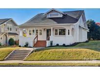 Charming craftsman home with white exterior, wood steps, and manicured lawn at 103 2Nd Nw Ave, Hickory, NC 28601