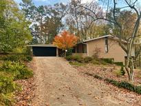 Brick ranch home with attached garage and mature trees at 423 Whitestone Rd, Charlotte, NC 28270