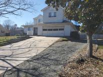 Charming two-story home with a large driveway and attached two-car garage, perfect for a Gathering at 8540 Indian Summer Trl, Harrisburg, NC 28075