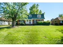 Charming two-story brick home with a lush green lawn and mature shade tree, offering classic curb appeal at 1018 Carysbrook Ln, Charlotte, NC 28217