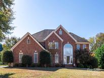 Brick two-story house with a large front yard and a three-car garage at 137 Huntfield Way, Mooresville, NC 28117