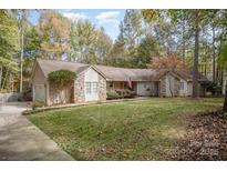 Charming home featuring a well-maintained lawn, stone accents, and an inviting entrance at 15450 Millview Trace Ln, Mint Hill, NC 28227