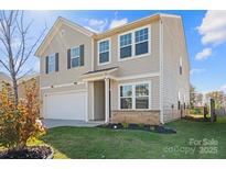 Two-story house with a spacious lawn and attached garage at 173 Hidden Lakes Rd, Statesville, NC 28677