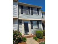 Charming two-story home with black shutters and well-maintained landscaping near the front door at 9424 Lexington Cir # F, Charlotte, NC 28213