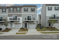 Modern townhome featuring a small balcony and a single-car garage in a residential neighborhood at 13047 Gadwal Pintail Dr, Charlotte, NC 28262