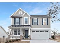 Two-story house with gray siding, metal roof, and a two-car garage at 2304 Catalina Ave, Charlotte, NC 28206