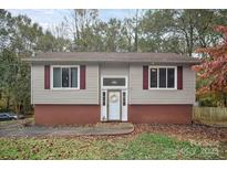 Charming single-Gathering home featuring vinyl siding, red shutters, and a welcoming front entrance with a decorative wreath at 914 Wyke Rd, Shelby, NC 28150