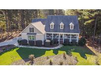 Charming home with a welcoming front porch, three dormer windows, and lush landscaping at 360 Lauren Pines Dr, York, SC 29745