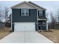 Two-story home with gray siding, white garage door, and landscaping at 362 Brinkley Dr # 142, Kings Mountain, NC 28086