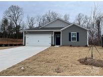 Gray exterior house with white garage door and landscaping at 404 Brinkley Dr # 141, Kings Mountain, NC 28086