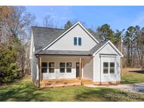 Charming new construction home featuring light gray siding, a covered porch, and a well-manicured front yard at 1436 Panther Rd, Lancaster, SC 29720