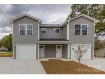 New gray townhome offers a front-entry two-car garage and covered front porch at 2014 Crown Point Dr # 2008-B, Albemarle, NC 28001