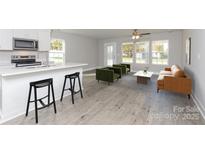 Open floor plan offers a smooth transition between the kitchen and well-lit living area at 2014 Crown Point Dr # 2008-B, Albemarle, NC 28001