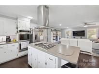 Modern kitchen with island, stainless steel appliances, and view to living room at 1926 Hopewell Church Rd, Sherrills Ford, NC 28673