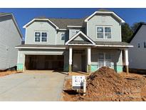 Two-story house with gray siding, attached garage, and landscaping at 1017 Wandsworth Pl # Ken0108, Charlotte, NC 28215