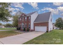 Traditional two-story brick home with a two-car garage and well-maintained landscaping at 2512 Holly Oak Ln, Gastonia, NC 28056