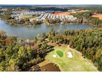 Expansive aerial view of community, golf course, and lakefront homes surrounded by lush green landscape and mature trees at 25566 Seagull Dr, Lancaster, SC 29720