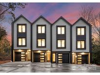 Three-unit modern townhome building with attached garages and contemporary design at 162 Mattoon St, Charlotte, NC 28216