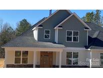 Charming home featuring a stone foundation, wood-look siding, and a classic roofline at 217 Heartland Dr, Rock Hill, SC 29732