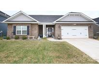 Charming single-story brick home featuring a well-manicured lawn and attached two-car garage at 126 Fleming Dr, Statesville, NC 28677