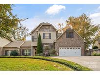 Two-story brick home with a large driveway and landscaping at 119 42Nd Avenue Nw Dr, Hickory, NC 28601