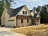 Beautiful brick home featuring a two-car garage, complemented by manicured landscaping at 315 Bonaventure Dr, Salisbury, NC 28147