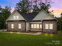Charming brick home featuring a well-manicured lawn and inviting front porch at 315 Bonaventure Dr, Salisbury, NC 28147