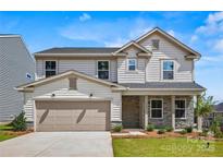 Charming two-story home featuring stone accents, a two-car garage, and manicured landscaping at 5149 Hales Ford Rd # 020, Charlotte, NC 28215