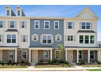 Two-story townhouses with gray siding, stone accents, and landscaping at 7109 Brookview Ln, Sherrills Ford, NC 28673