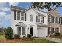 Two-story townhome with white siding and a black door at 105 Beverly Chase Ln, Mooresville, NC 28117