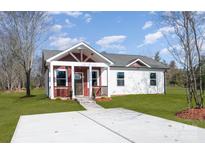 Charming single-Gathering home features a well-manicured lawn, inviting entrance, and stylish architectural details at 1244 Bob Falls Rd, Shelby, NC 28150