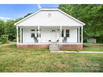 Charming white home with a cozy front porch and inviting curb appeal at 2401 Boy Scout Rd, Lincolnton, NC 28092