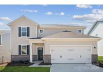 Charming two-story home featuring a two-car garage and beautifully designed brick and siding facade at 2561 Blue Sky Meadows Dr, Monroe, NC 28110