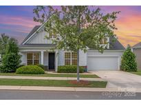 Charming two-story home featuring manicured lawn, a two-car garage and inviting front porch at 3029 Quinebaug Rd, Fort Mill, SC 29715