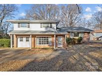 Brick ranch house with attached garage and landscaped yard at 2810 Daleview Dr, Charlotte, NC 28214