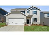 Charming two-story home with a two-car garage and manicured lawn at 550 Mountain View Dr, Monroe, NC 28110