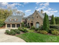 Brick house with three-car garage and landscaped yard at 6828 Alexander Rd, Charlotte, NC 28270