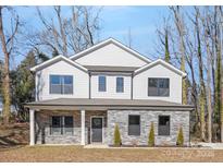 Two-story house with gray siding, stone accents, and a front porch at 8001 Willhill Rd, Charlotte, NC 28227