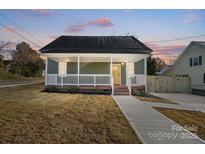 Charming craftsman style home with a welcoming front porch and landscaped yard at 102 S Liberty St, Gastonia, NC 28052