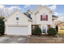 Two-story house with attached garage, viewed from the driveway at 13039 Peacock Ln, Charlotte, NC 28215