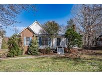 Charming single-Gathering home features a brick accent, blue shutters, and a well-maintained front lawn at 117 Eagle Ct, Mooresville, NC 28117