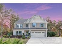 Charming two-story home featuring a well-maintained front yard, attached two-car garage, and classic architectural details at 6003 Hawk View Rd, Waxhaw, NC 28173