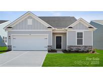 Charming single-story home with a two-car garage, black front door, and a well-manicured lawn at 885 Exeter Dr, Sherrills Ford, NC 28673