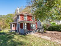 Charming two-story home with a covered front porch and mature landscaping at 1411 Lineberger Ave, Gastonia, NC 28052