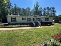 Charming single-story home featuring a well-manicured front yard and welcoming entrance stairs at 2164 Mission Rd, York, SC 29745