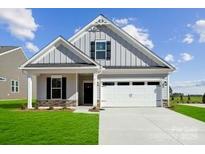 Charming single-story home with vertical siding, an attached two-car garage, and a well-manicured lawn at 8364 Acadia Pkwy, Sherrills Ford, NC 28673